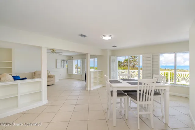 a view of a dining room with furniture and a large window