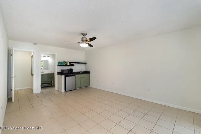 a kitchen with granite countertop a sink cabinets and stainless steel appliances