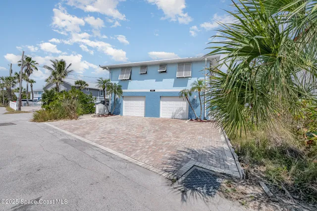 a view of a house with a yard and basketball area