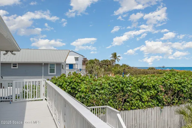 a balcony with wooden fence and city view