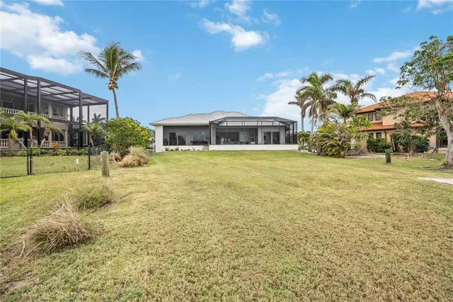 an aerial view of a house with swimming pool and lake view