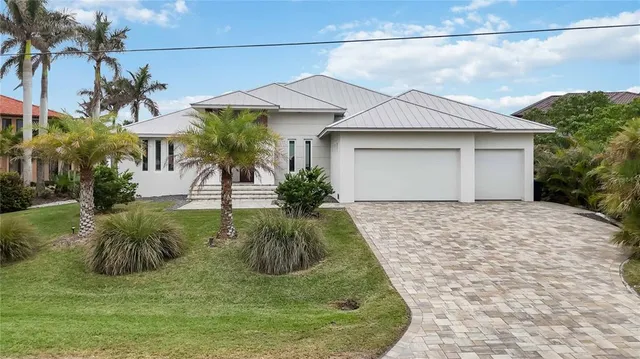 an aerial view of residential houses with outdoor space and parking