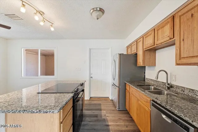 an empty room with a chandelier fan