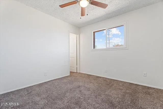 an empty room with a ceiling fan