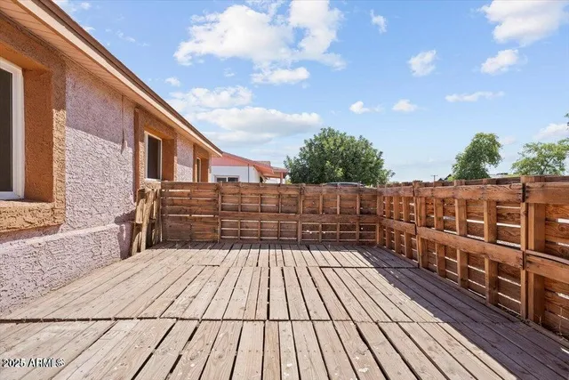 a living room with furniture a lamp and a potted plant