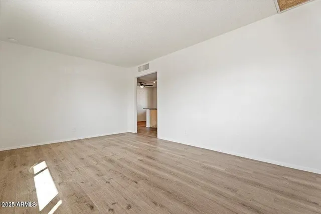 an empty room with windows and closet