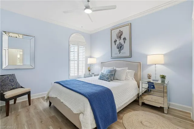 a bedroom with a bed and a lamp on a dresser