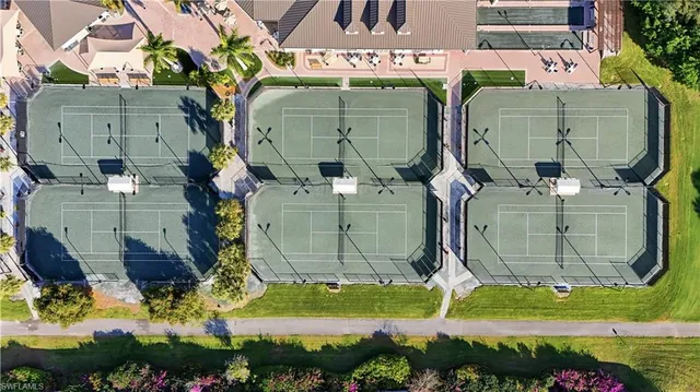 an aerial view of residential houses with outdoor space and swimming pool