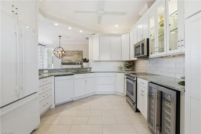 a kitchen with a refrigerator and a sink