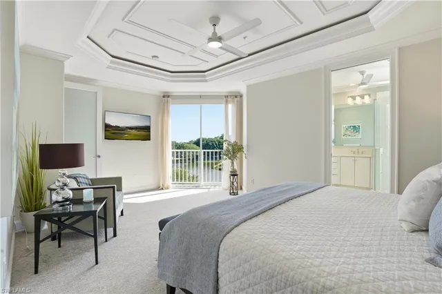 a spacious bedroom with a bed and a chandelier