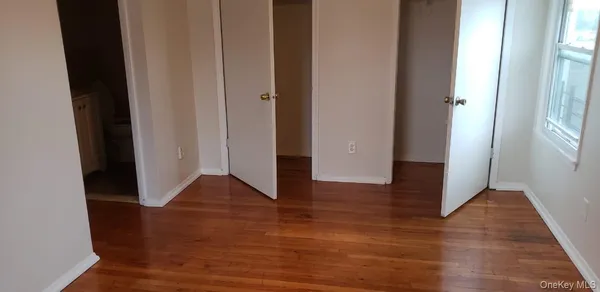 a view of entryway with wooden floor and door