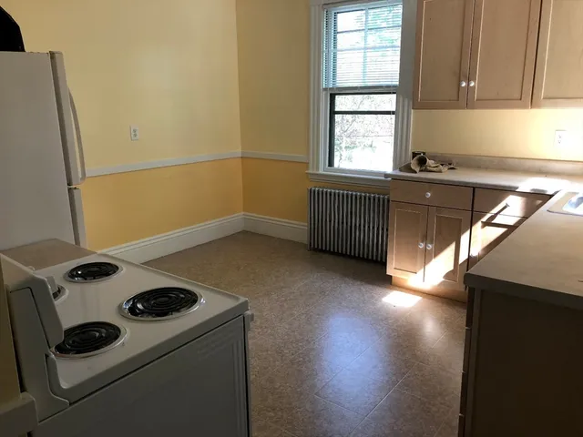 a kitchen that has a stove and a microwave