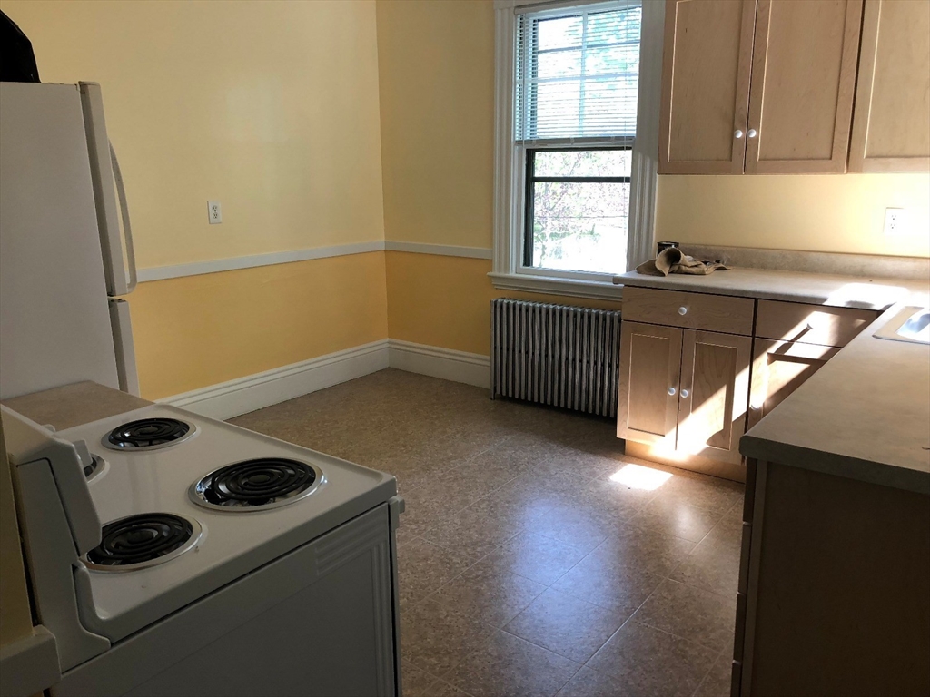 52 Pleasant Street, Unit 2 Lexington, MA 02421 - Photo 12 of 13 a kitchen that has a stove and a microwave