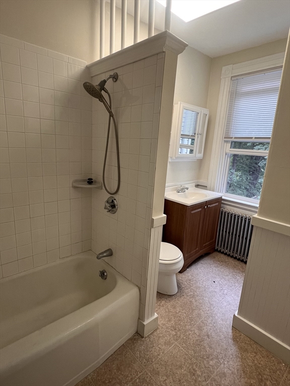 52 Pleasant Street, Unit 2 Lexington, MA 02421 - Photo 6 of 13 a bathroom with a granite countertop sink a toilet and shower
