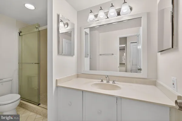 a bathroom with a sink vanity toilet and shower