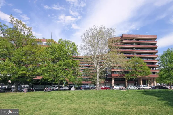 a view of a building with a window and car parked