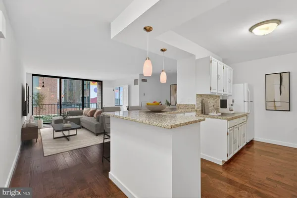 a large white kitchen with a stove and a refrigerator
