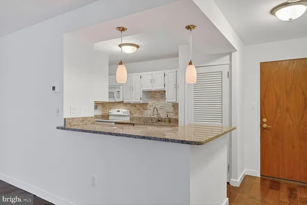 a kitchen with stainless steel appliances granite countertop a sink and a refrigerator