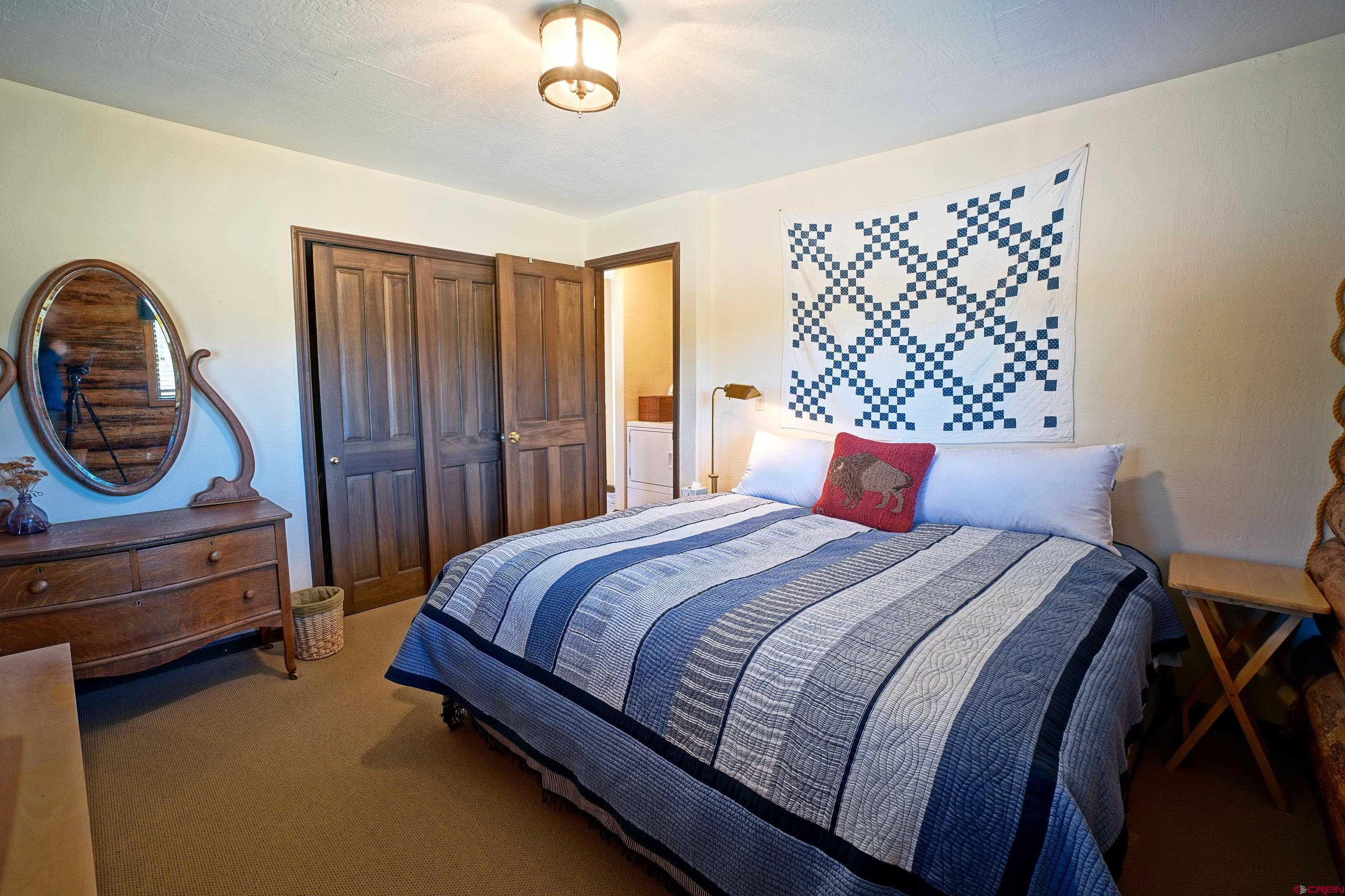 76 Tower Road South Ridgway, CO 81432 - Photo 14 of 37 a bedroom with a bed and a dresser