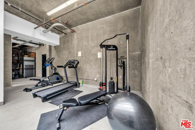a room with gym equipment and windows