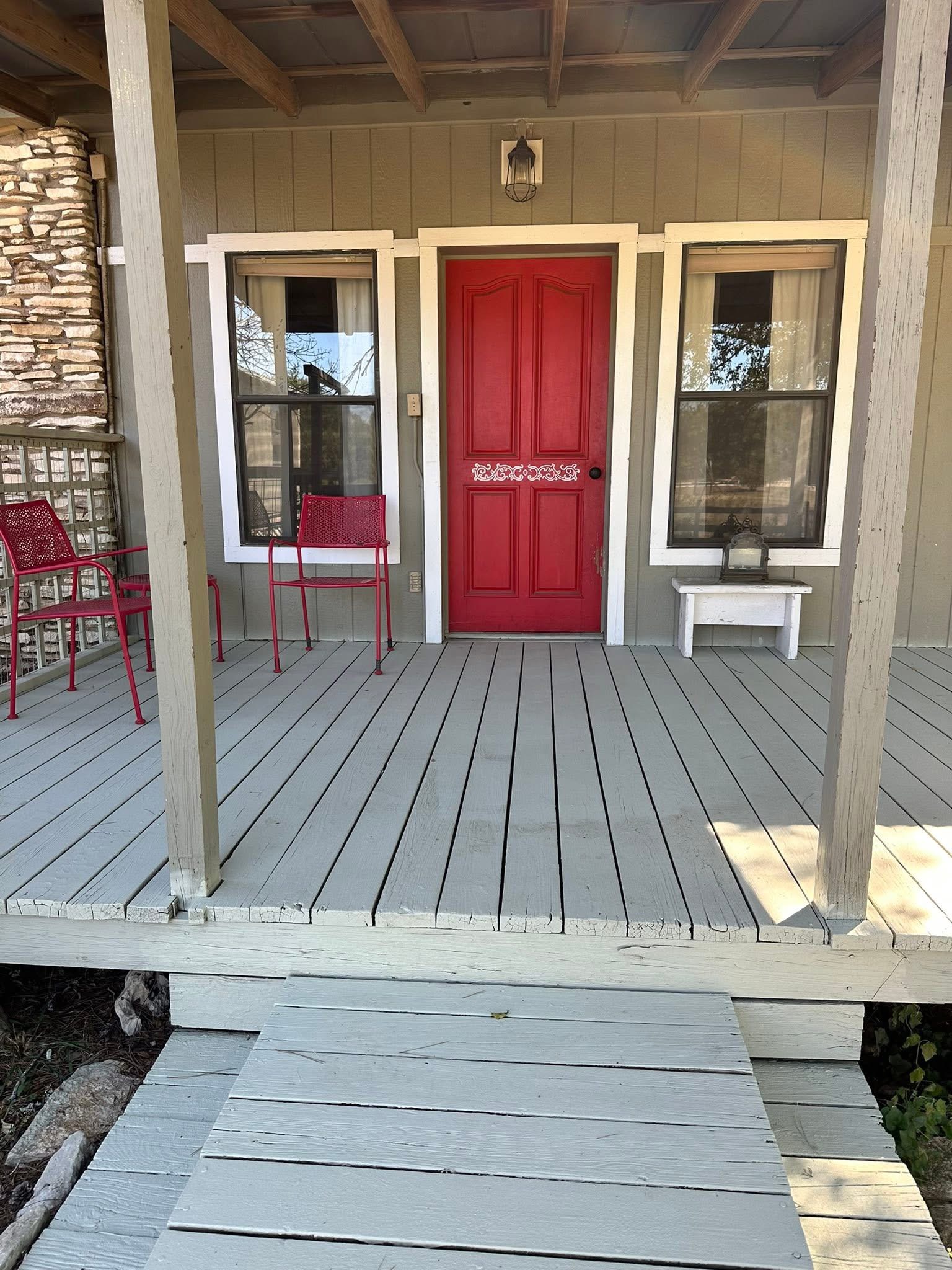 a room with wooden floor and windows