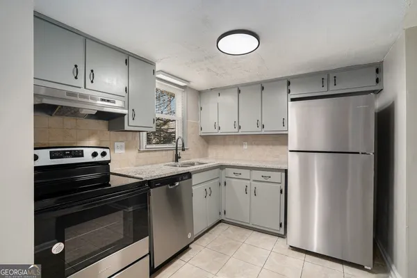a kitchen with a sink stainless steel appliances and cabinets