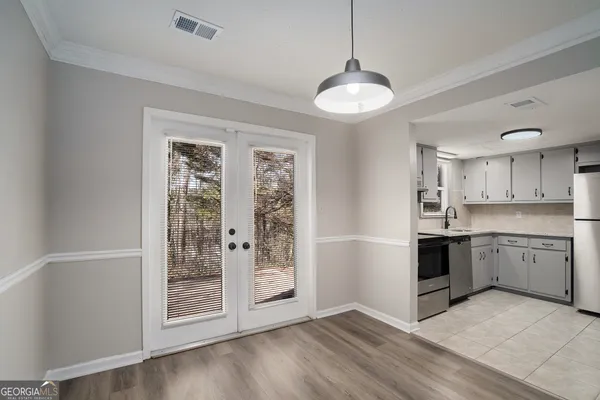 a large kitchen with cabinets and wooden floor