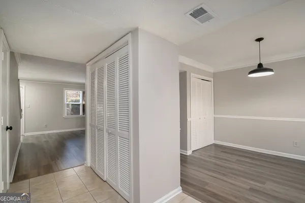 a view of empty room with wooden floor