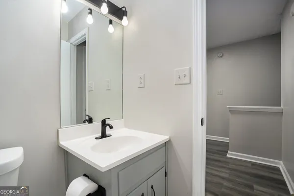 a bathroom with a sink toilet and vanity