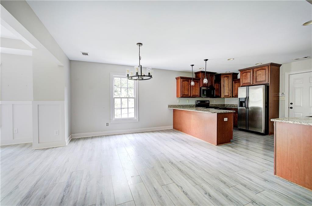 561 Holland Road Dallas, GA 30157 - Photo 8 of 48 a view of kitchen with sink microwave refrigerator and cabinets