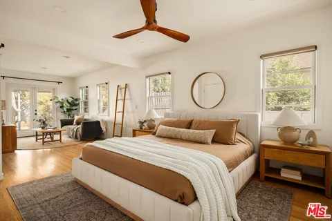 a bedroom with bed and a large window