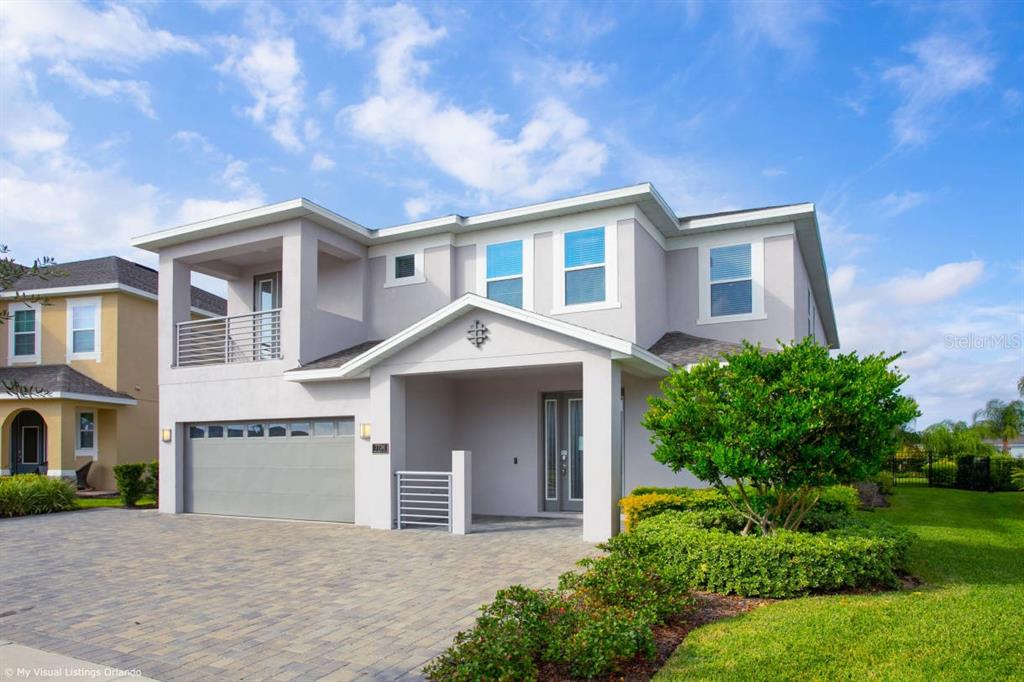 7736 Graben Street Kissimmee, FL 34747 - Photo 1 of 62 a front view of a house with a garden