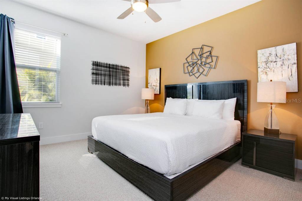 7736 Graben Street Kissimmee, FL 34747 - Photo 14 of 62 a large bed sitting in a bedroom next to a window