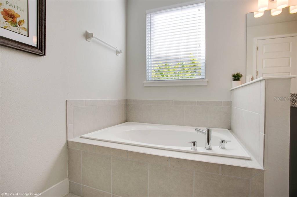 7736 Graben Street Kissimmee, FL 34747 - Photo 17 of 62 a white bath tub sitting next to a window