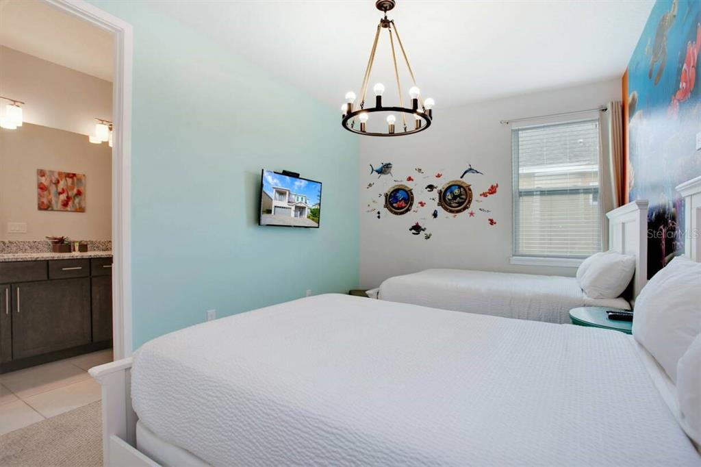 7736 Graben Street Kissimmee, FL 34747 - Photo 20 of 62 a bedroom with a bed and a table