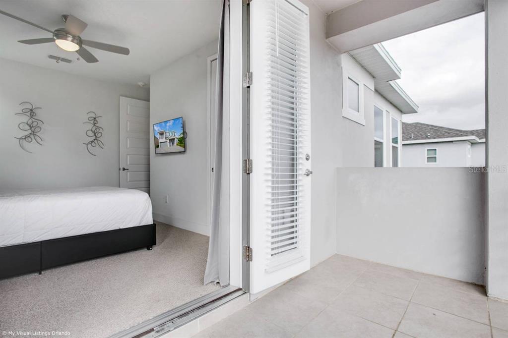 7736 Graben Street Kissimmee, FL 34747 - Photo 25 of 62 a bedroom with a bed and a chandelier