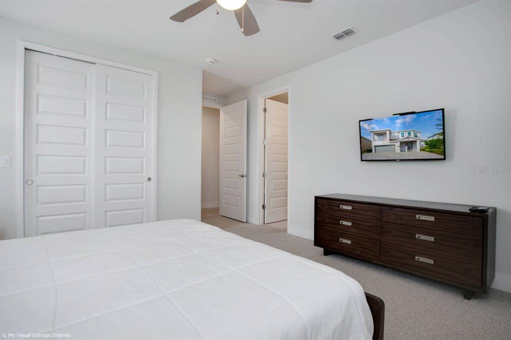 7736 Graben Street Kissimmee, FL 34747 - Photo 27 of 62 a bedroom with a bed and a painting on the wall