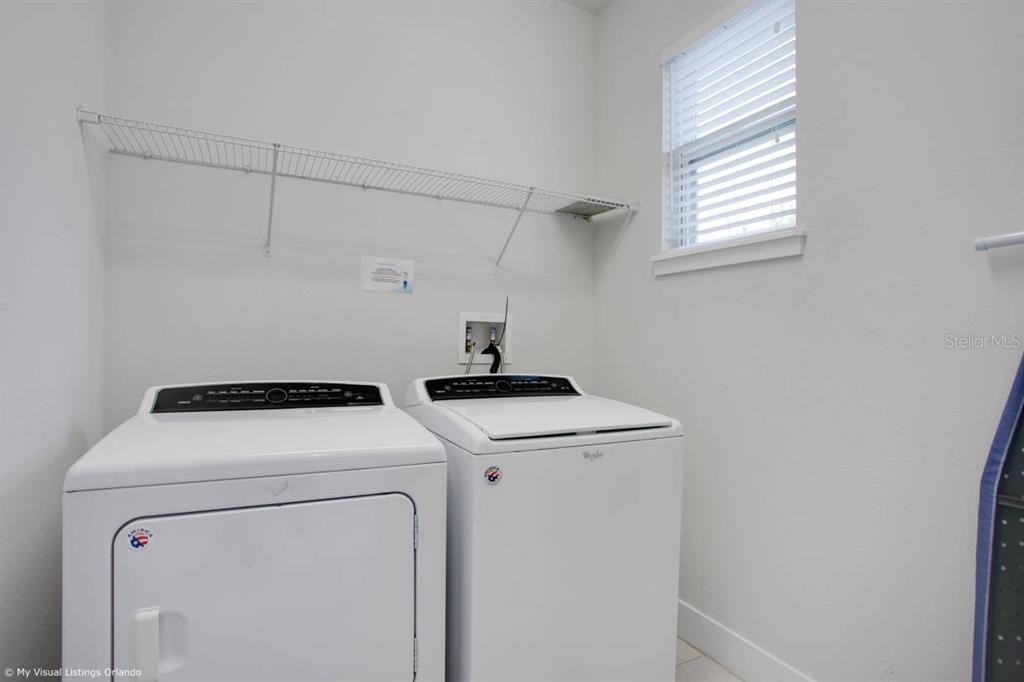 7736 Graben Street Kissimmee, FL 34747 - Photo 30 of 62 a utility room with dryer and washer