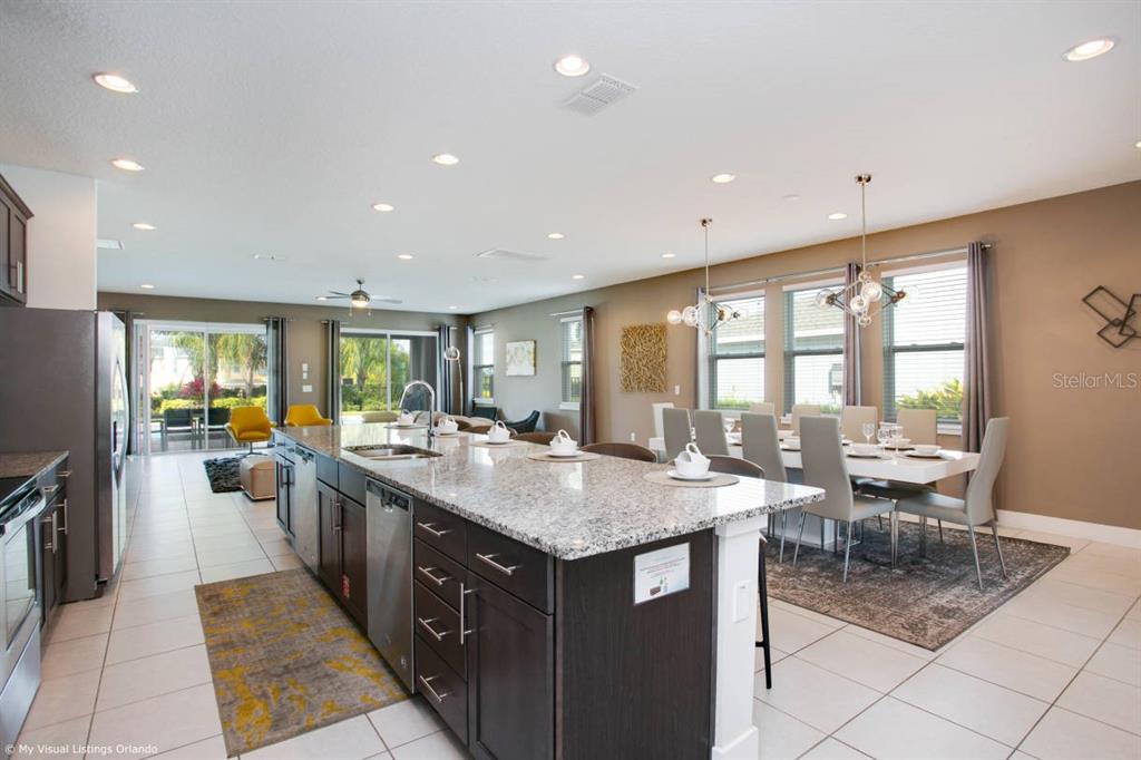 7736 Graben Street Kissimmee, FL 34747 - Photo 37 of 62 a kitchen with center island and stainless steel appliances