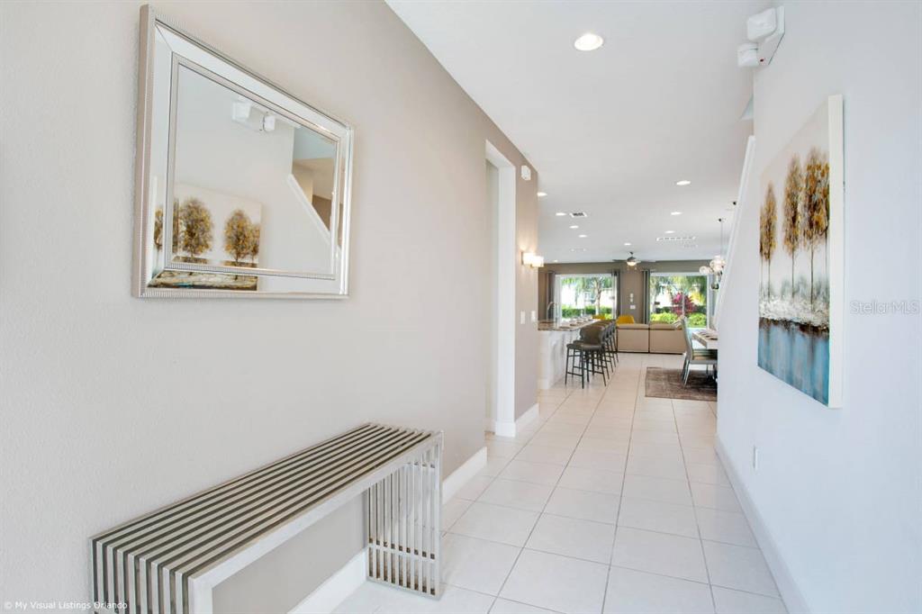 7736 Graben Street Kissimmee, FL 34747 - Photo 41 of 62 a view of a hallway with wooden floor and a large mirror
