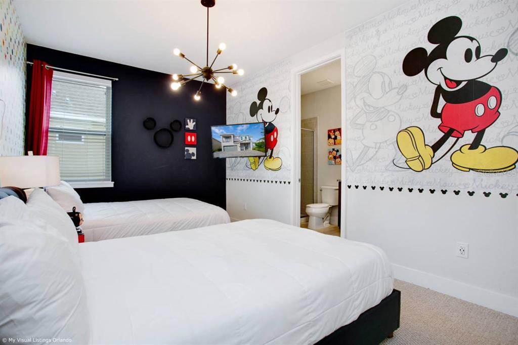 7736 Graben Street Kissimmee, FL 34747 - Photo 43 of 62 a bedroom with a bed and a chandelier