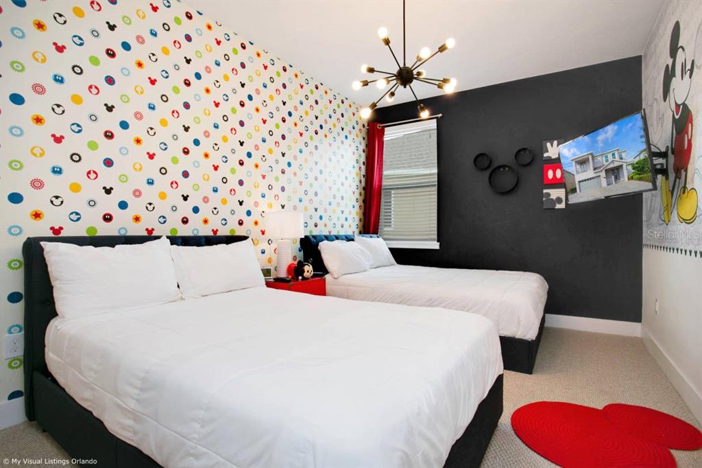 7736 Graben Street Kissimmee, FL 34747 - Photo 54 of 62 a bedroom with a bed and a flat screen tv