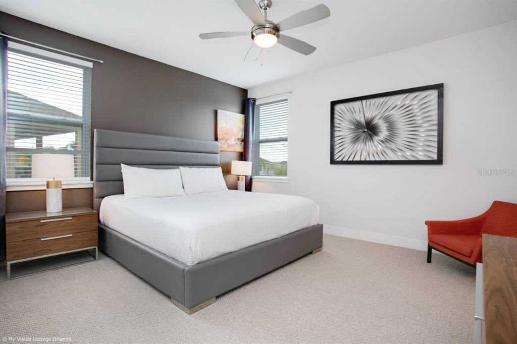7736 Graben Street Kissimmee, FL 34747 - Photo 55 of 62 a bedroom with a bed and a painting on the wall