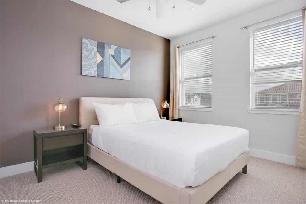 7736 Graben Street Kissimmee, FL 34747 - Photo 56 of 62 a bedroom with a bed and a night stand