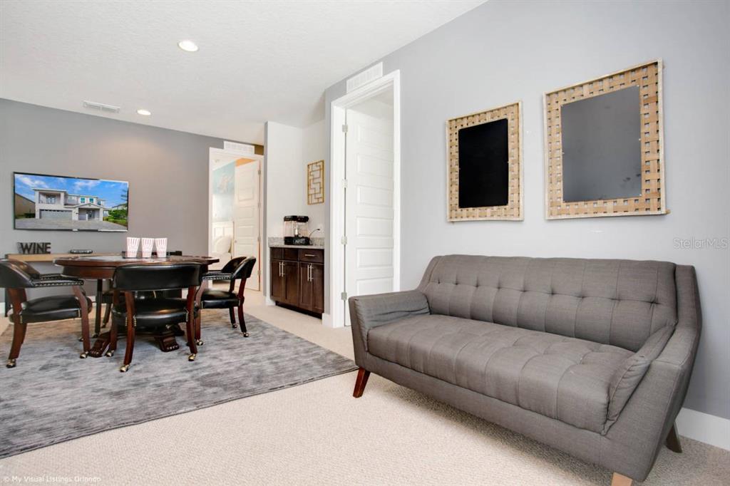 7736 Graben Street Kissimmee, FL 34747 - Photo 59 of 62 a living room with furniture wooden floor and dining room