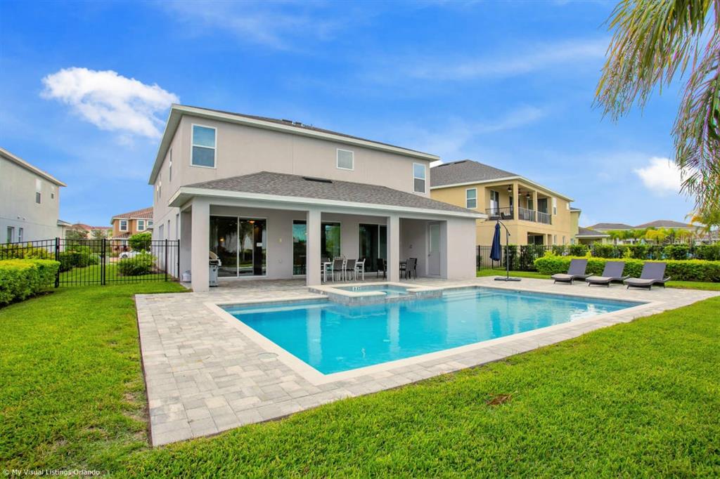 7736 Graben Street Kissimmee, FL 34747 - Photo 6 of 62 a view of a house with swimming pool and a yard