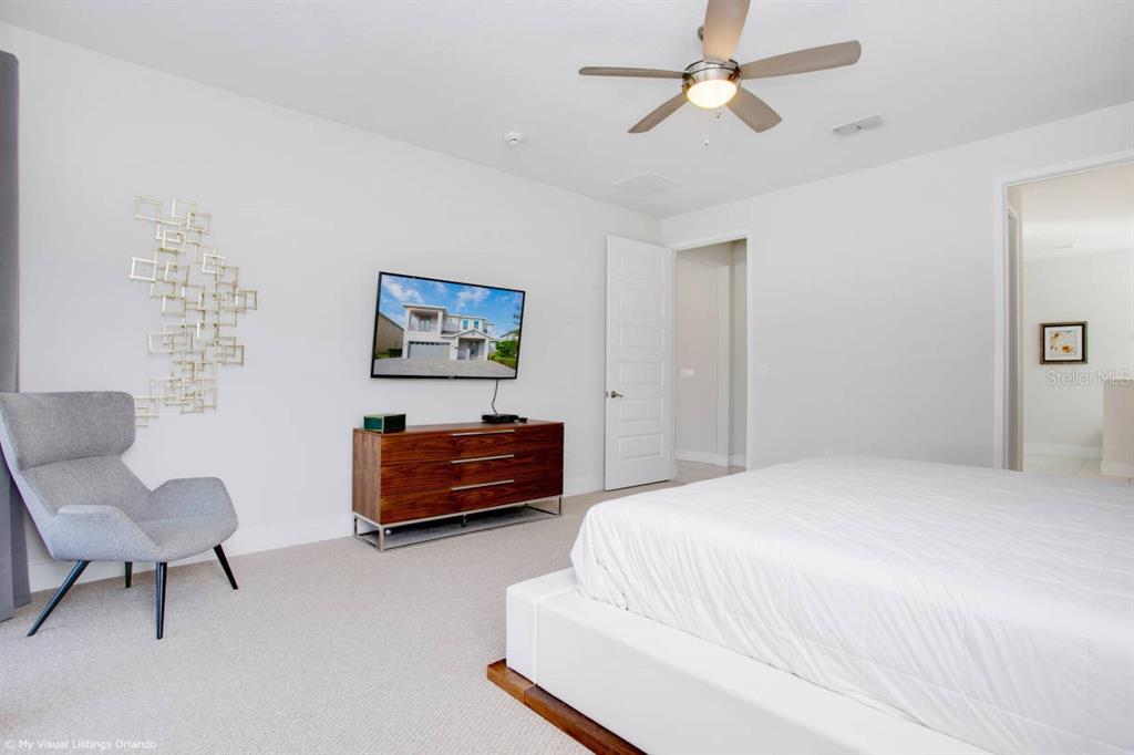 7736 Graben Street Kissimmee, FL 34747 - Photo 9 of 62 a bedroom with furniture and a chandelier