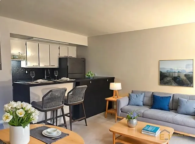 a kitchen with a refrigerator and a stove top oven