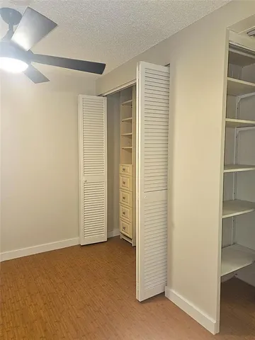 a kitchen with a table chairs refrigerator and microwave