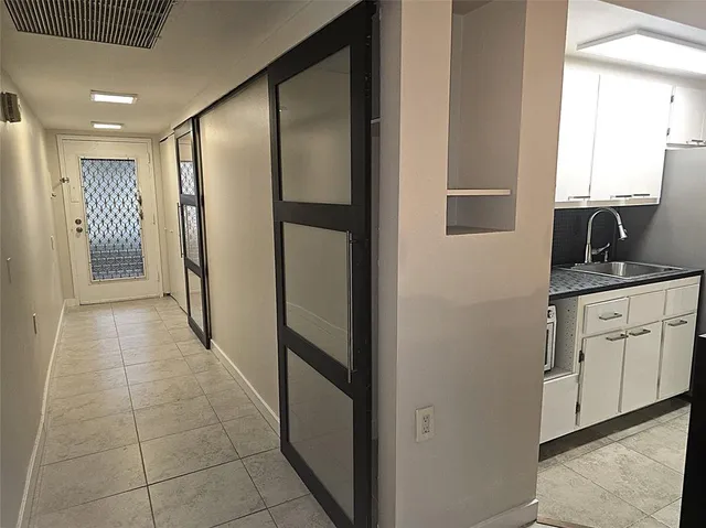 a kitchen with stainless steel appliances granite countertop white cabinets and a refrigerator